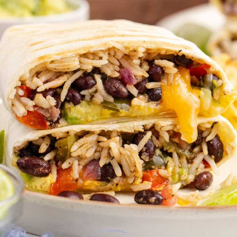 square image of a burrito cut in half showing the ingredients