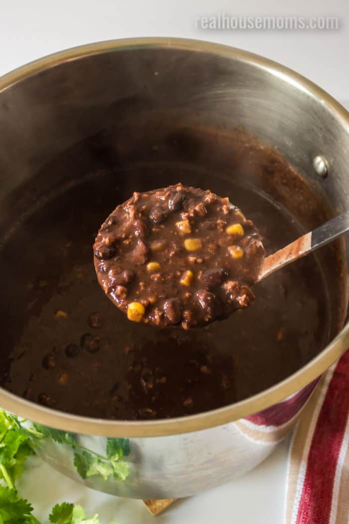 ladle of black bean soup after cooking