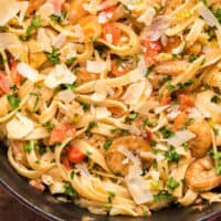 blackened shrimp & lobster pasta in a pot with recipe name at the bottom