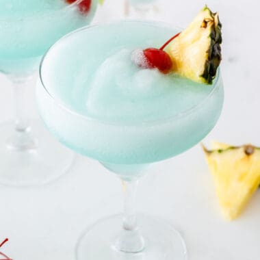 square image of a frozen blue margarita in a margarita glass