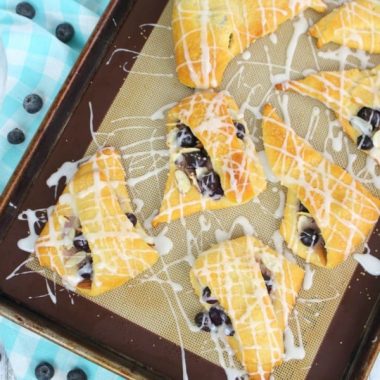 If breakfast pastries are your thing then these Blueberry Almond Turnovers are for you! This delicious turnover recipe is made with refrigerated crescent roll dough a super easy breakfast treat!