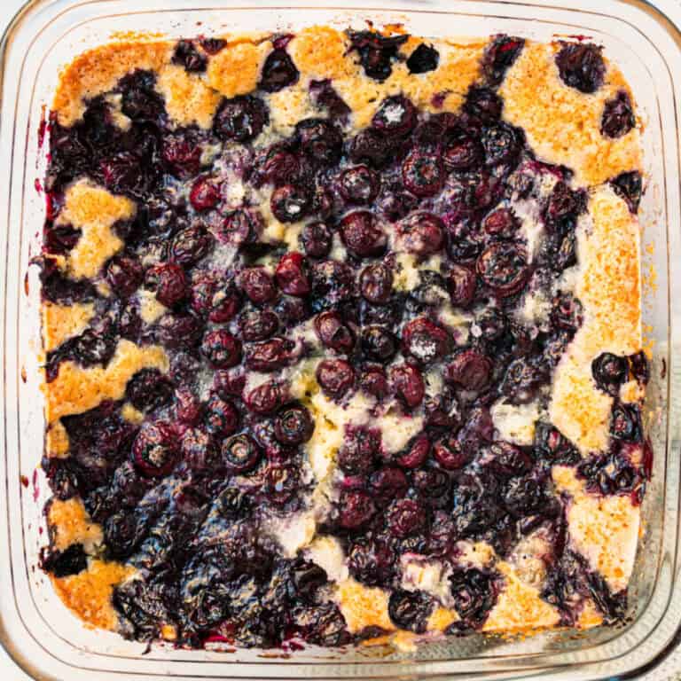 square image of blueberry cobbler in a square baking dish