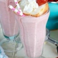This BOOZY STRAWBERRY SHORTCAKE MILKSHAKE is EPIC!! Strawberries, Cake Vodka, and ACTUAL cake topped with more cake, whipped cream, and a strawberry! You can have your cake and drink it too!