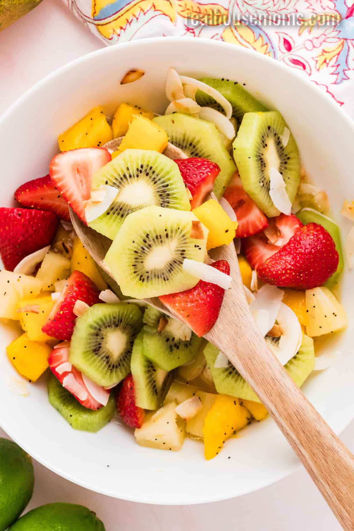 spoonful of boozy tropical fruit salad over the serving bowl