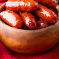 bourbon brown sugar smokies in a wooden bowl with recipe name at the bottom