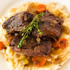 Braised Short Ribs are slow cooked in red wine until fork tender for a cozy and elegant dinner. They make great leftovers too!