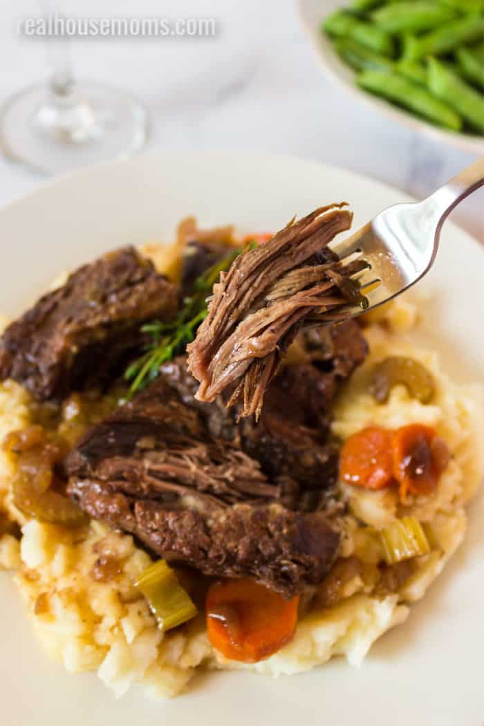 fork with a bite of braised short ribs