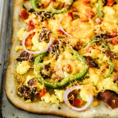 square image of breakfast pizza on a baking sheet