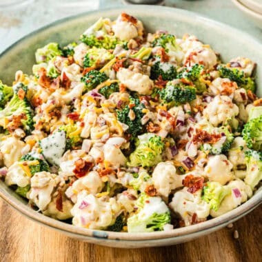 square image of broccoli cauliflower salad in a serving bowl