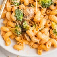 broccoli pasta on a plate with a fork with recipe name at the bottom