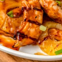 close up of brown sugar pineapple chicken on a platter with recipe name at the bottom