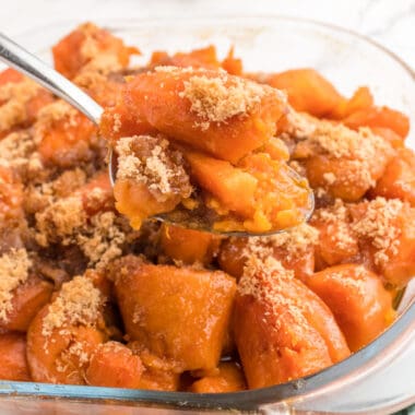 square image of a spoonful of brown sugar and maple sweet potatoes over the casserole dish