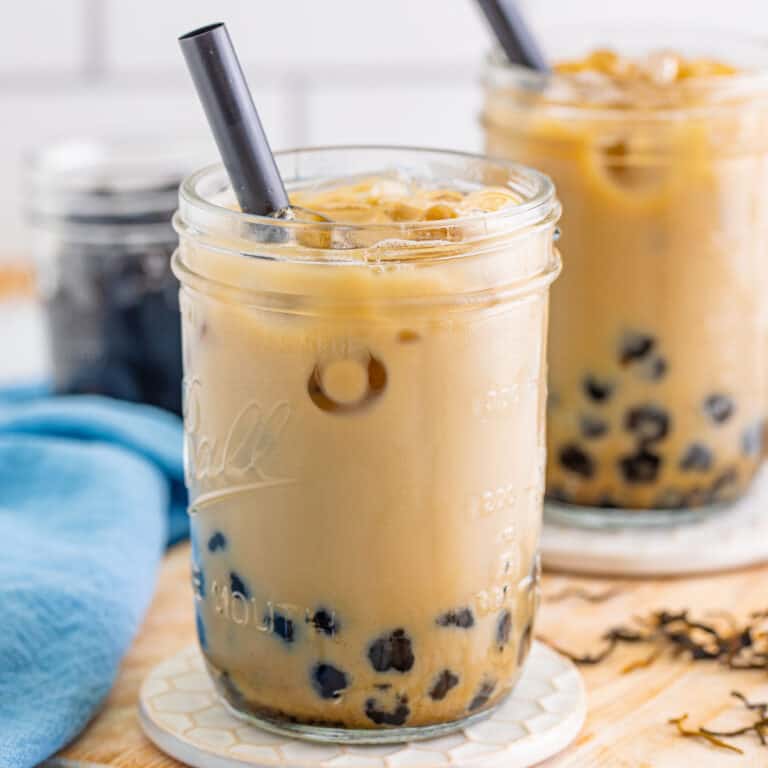 square image of bubble tea in mason jars with straws