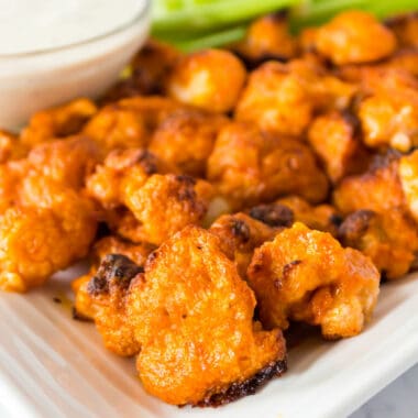Buffalo Cauliflower Bites are the perfect game day appetizer! This secretly healthy recipe is so good, no one will miss chicken wings!
