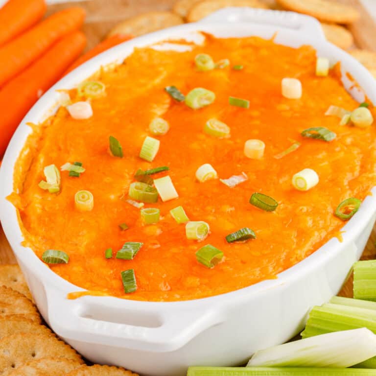 square image of buffalo cauliflower dip in a white baking dish