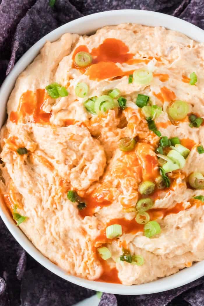 buffalo chicken dip topped with green onions and extra hot suace
