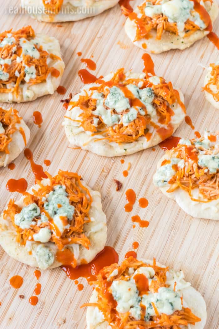 buffalo chicken pizza bites drizzled with extra hot sauce