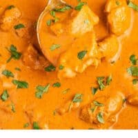 spoonful of butter chicken over the skillet with recipe name at the bottom