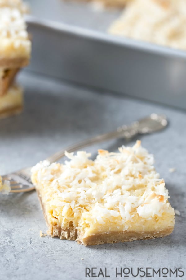 A Buttery Coconut Bar with a bite missing that has been taken with a fork
