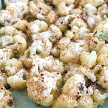 Delicious, crispy, AND healthy Cheesy Roasted Cauliflower is the ideal low-carb side dish! Serve it with all your favorite meals or as a yummy vegetarian dish!