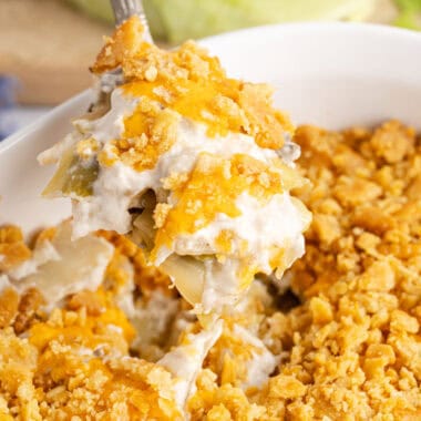 square image of a spoon full of cabbage casserole