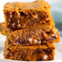 square image close up of caramel pumpkin blondies stack up on a plate