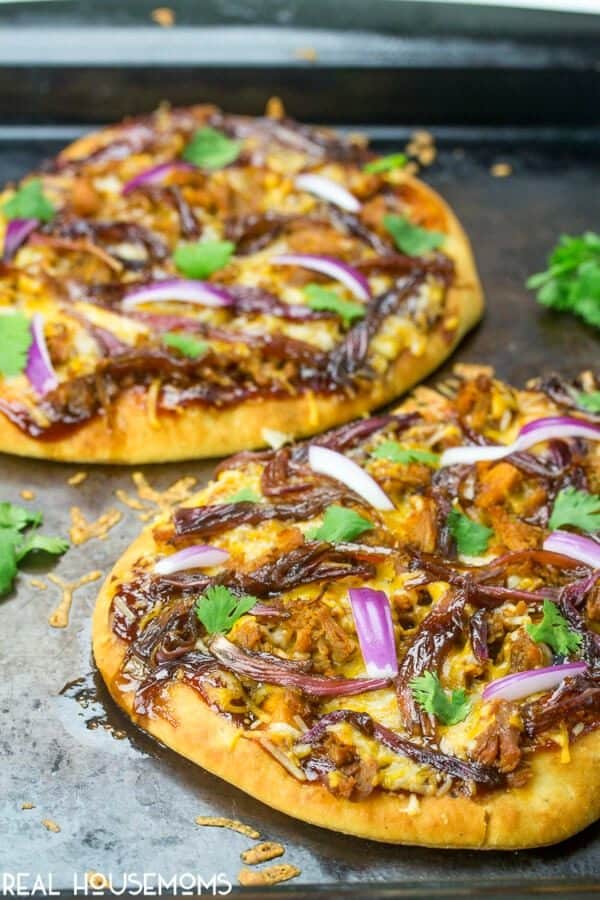 Cooked Caramelized Onion and BBQ Pork Flatbread topped with raw red onion and cilantro