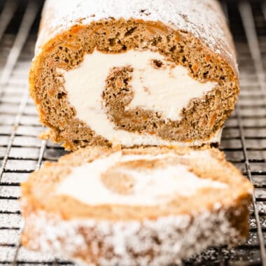 square image a a carrot cake swiss roll with a slice laid down