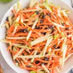 square image of carrot and apple slaw in a serving bowl