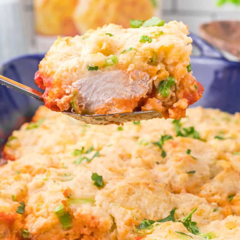 square image of a serving of cheddar bay chicken bake on a spoon over the dish
