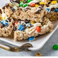 cheerio cereal bars piled on a platter with recipe name at the bottom