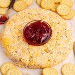 square image of a cheese ring with a bowl of strawberry jam in the center