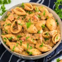 square image of cheesy beef and shells in a bowl