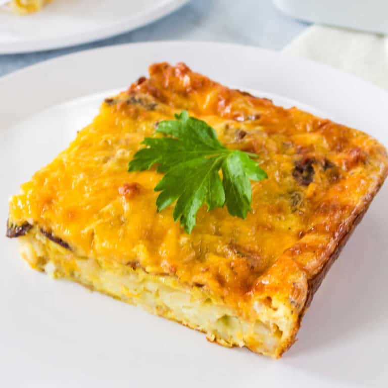 Hash browns layered with all your breakfast favorites & then baked to perfection make this Cheesy Breakfast Casserole with Bacon & Eggs a yummy brunch dish!