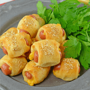 Cheesy Pigs in a Blanket are a kid-friendly and crowd pleasing appetizer. Using only 5 ingredients, these come together in a snap!