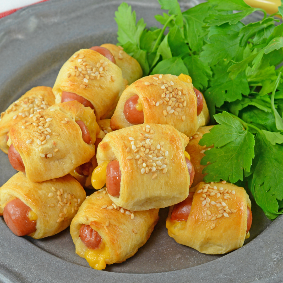 Cheesy Pigs in a Blanket are a kid-friendly and crowd pleasing appetizer. Using only 5 ingredients, these come together in a snap!