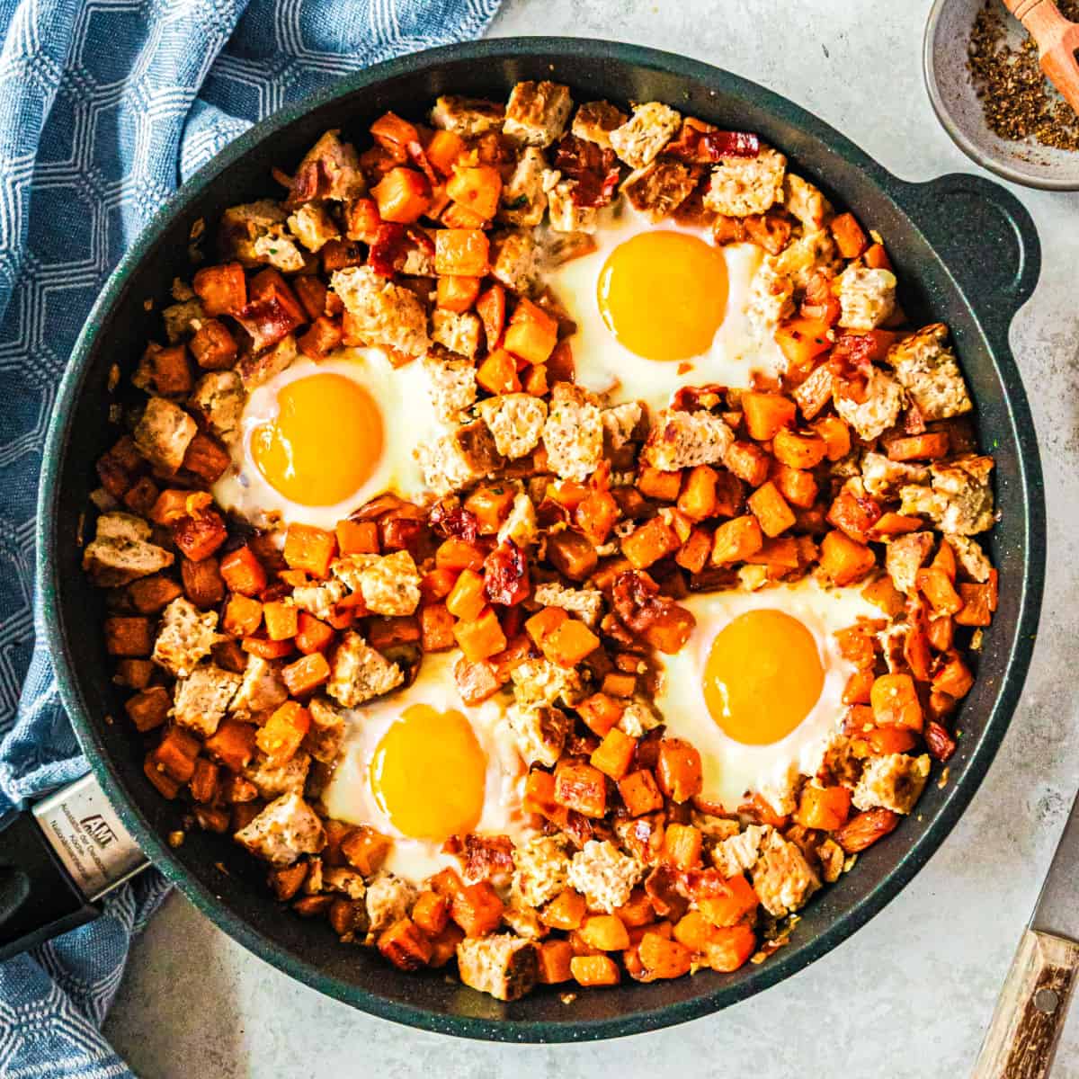 square image of chicken apple sausage & sweet potato hash in a skillet
