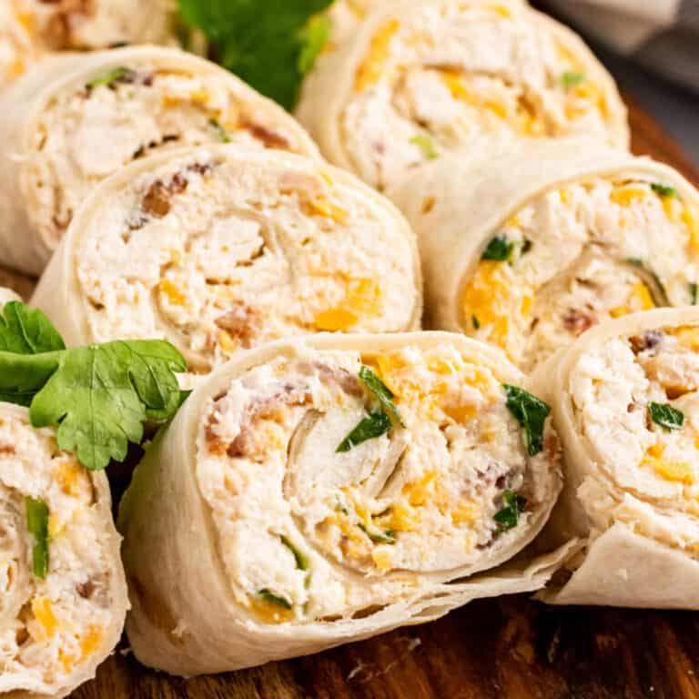 square image of chicken bacon ranch pinwheels on a cutting board