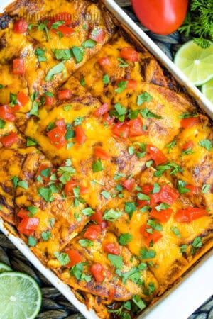 image of chicken enchilada casserole cut into squares in a white baking dish