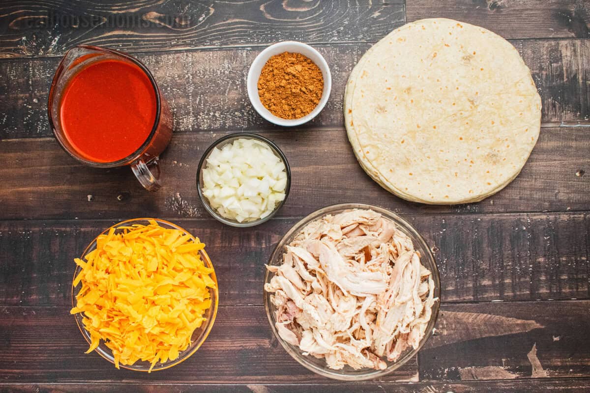 ingredients to make chicken enchilada casserole laid out on a counter