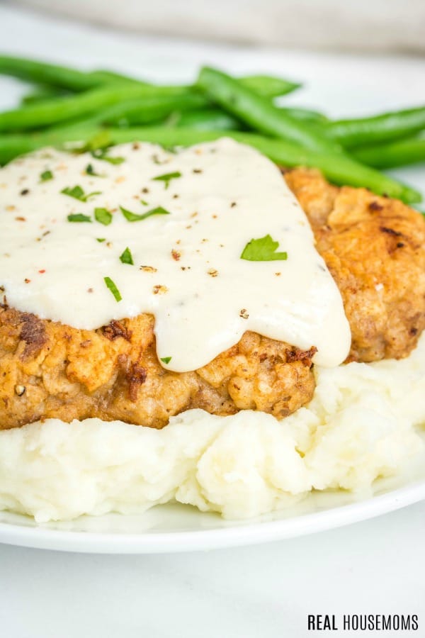 close up of chicken fried steak smothered in country gravy