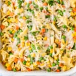square image of chicken noodle casserole in a white baking dish