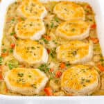 square image of chicken pot pie casserole topped with biscuits