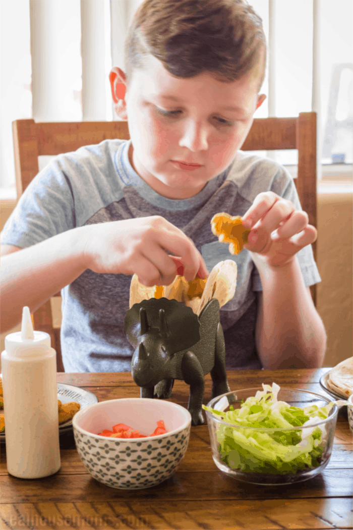 boy making chicken soft tacos