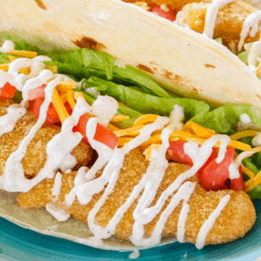 Easy Chicken Soft Tacos are a kid-approved taco night win! Crispy chicken and taco fixings are drizzled with homemade crema sauce for a quick 15-minute meal!