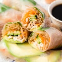 square image of chicken spring rolls cut in half