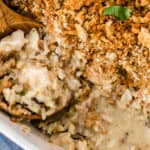 square image of chicken & wild rice casserole with a portion taken out to show creamy filling