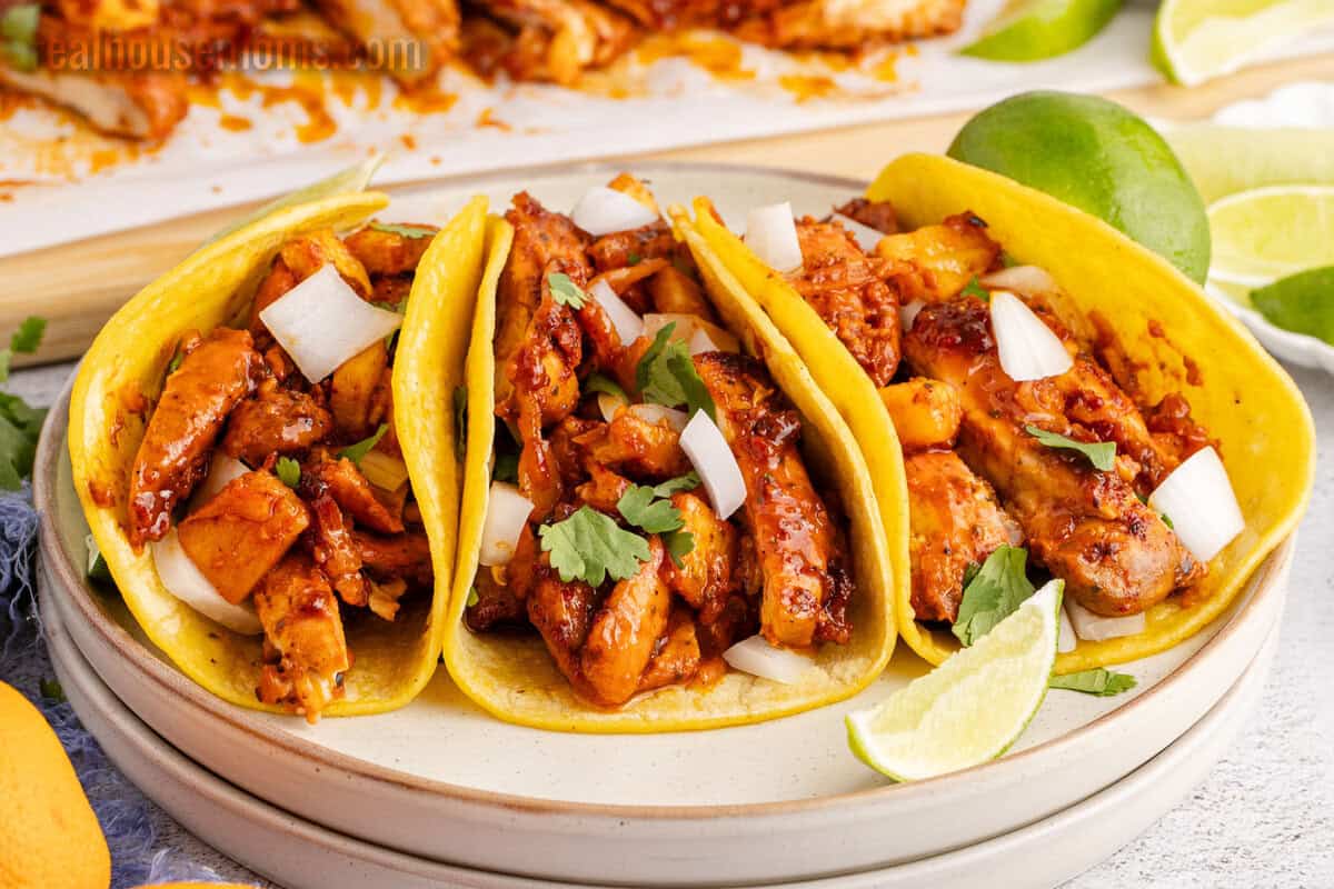 three chicken al pastor tacos on a plate