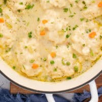 looking down at a pot of chicken and dumplings with recipe name at the bottom