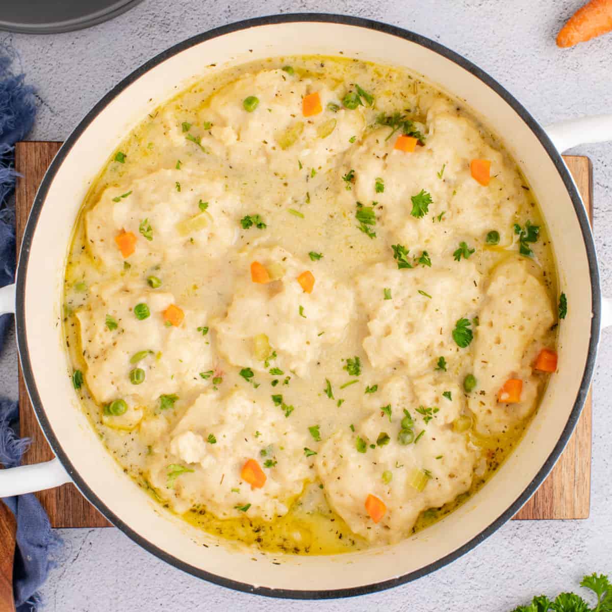 square image looking down at chicken and dumplings in a dutch oven